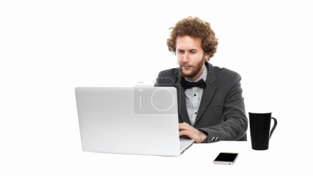 Photo for Portrait of funny businessman with bow tie who using laptop ana sceptical looking isolated on white background. Business concept - Royalty Free Image
