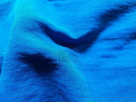 Blue clothing fabric texture or sports cloth or thread closeup textile background. 