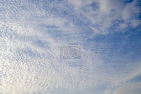 Photo for A breathtaking photograph capturing the vast blue sky adorned with numerous fluffy white clouds, radiating tranquility and serenity. - Royalty Free Image