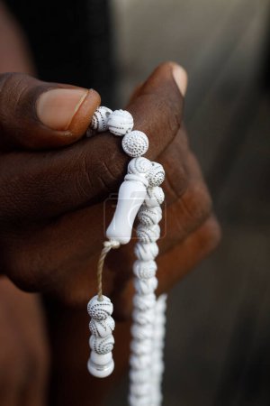 Téléchargez les photos : African muslim man praying.  Islamic prayer beads (tasbih). Close-up on hands.  Togo. - en image libre de droit