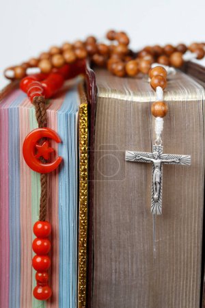 Photo for Religious symbols. Quran, bible and prayer beads. Christianity, Islam. Interfaith dialogue.  France. - Royalty Free Image