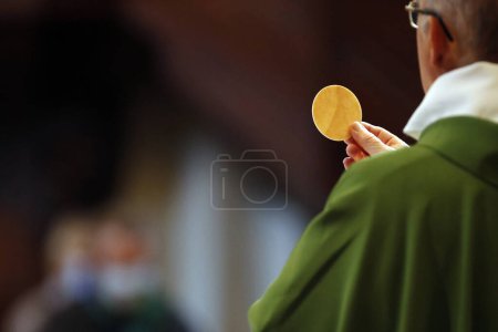 Photo for Catholic church during covid-19 epidemic. Sunday mass.  Priest at eucharistic celebration.  Sallanches.  France. - Royalty Free Image