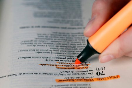 Photo for Woman studying the bible. Close up on hand and highlighter.   France. - Royalty Free Image
