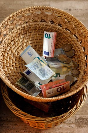 Photo for Collection During a Catholic Mass. Basket with Euros. Annecy.  France. - Royalty Free Image