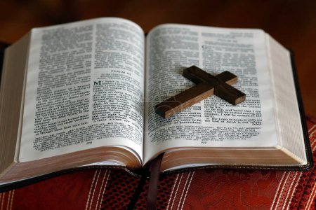 Open bible with a wooden cross.