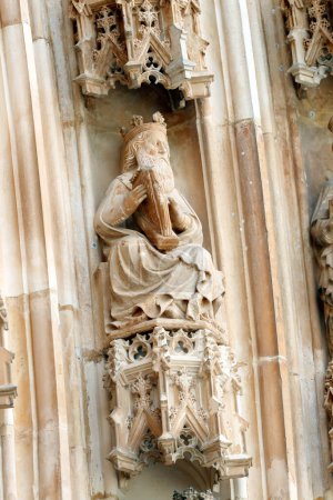 Photo for Batalha Monastery. Late Gothic architecture, intermingled with the Manueline style. Western portal. King David with playing the harp. Portugal. - Royalty Free Image