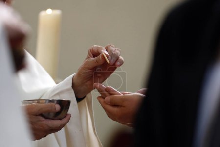 Sonntagsmesse in einer katholischen Pfarrei. Priester spendet Heilige Kommunion