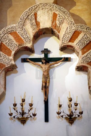 Photo for Mosque Cathedral of Cordoba. Christian crucifiction motive below Moorish architectural elements. Spain. - Royalty Free Image