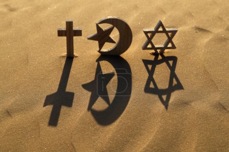 Photo for Religious symbols on sand at sunset :  Jewish Star of David, Muslim Star and Crescent and Catholc Cross.  Interreligious, interfaith and spirituality concept - Royalty Free Image