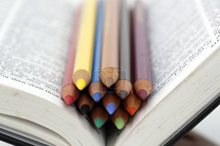 Photo for Colored pencils on a bible. Catechism. Christian curch. - Royalty Free Image