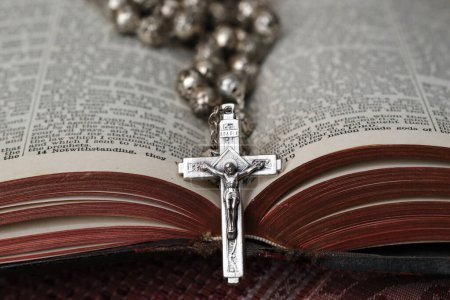 Téléchargez les photos : Chapelet vintage avec crucifix sur une Bible ouverte. Symbole religieux. - en image libre de droit
