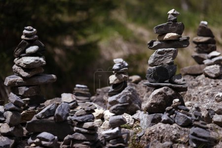 Photo for Close up on cairn, stoned pyramid, tourist memory sign on mountain path. - Royalty Free Image