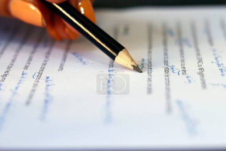 Close-up view of pencil on text of paper document.