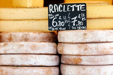 Traditional French cheese. The famous raclette, mountain cheese for sale at market. France. 