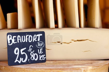 Traditional French cheese. The famous Beaufort, mountain cheese for sale at market