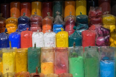 Foto de Set of plastic bags with traditional colorful gulal powders placed in row in local market in Hoi An Vietnam - Imagen libre de derechos