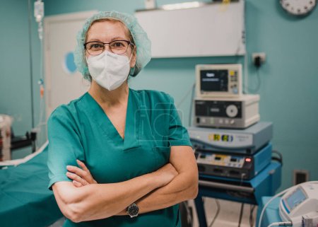 Photo for Portrait of female nurse looking at camera inside operating theater at private clinic - Focus on woman face - Royalty Free Image