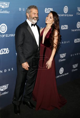 Photo for Mel Gibson and Rosalind Ross at the Art Of Elysium's 12th Annual Heaven Celebration held at the Private Venue in Los Angeles, USA on January 5, 2019. - Royalty Free Image