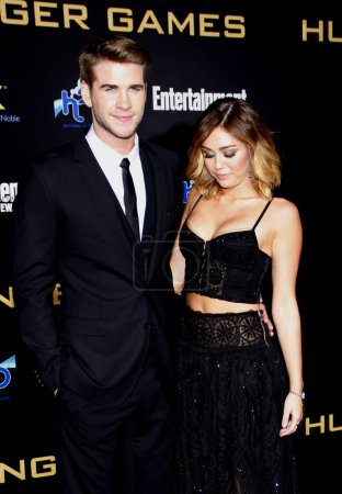 Photo for Liam Hemsworth and Miley Cyrus at the Los Angeles premiere of 'The Hunger Games' held at the Nokia Theatre L.A. Live in Los Angeles on March 12, 2012. - Royalty Free Image
