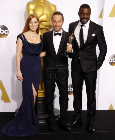 Photo for Emmanuel Lubezki, Jessica Chastain and Idris Elba at the 87th Annual Academy Awards - Press Room held at the Loews Hollywood Hotel  in Los Angeles on Sunday February 22, 2015. - Royalty Free Image