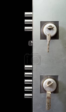 interior double door lock with keys isolated on black background