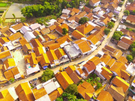 Aerial of Houses in Bandung Suburbs. An aerial view taken from a drone of a large housing estate in Bandung, Indonesia. Many similar houses in a dense development. 