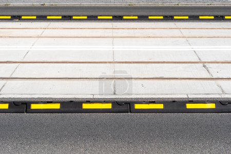 Photo for Closeup on road delineator for safety in city. Separator lines for cars and transportation. Roadway marking, barrier blocks on freeway. Warning elements on carriageway - Royalty Free Image