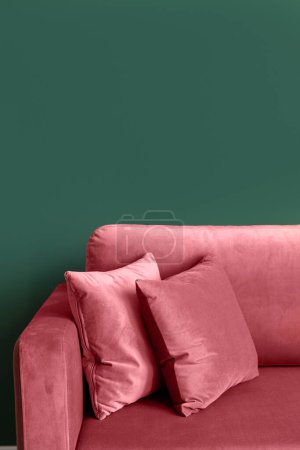 Photo for Vertical shot of red armchair with cushions in modern living room with green walls. Clean soft upholstery on furniture after replacement at tidy home. Copy space. - Royalty Free Image