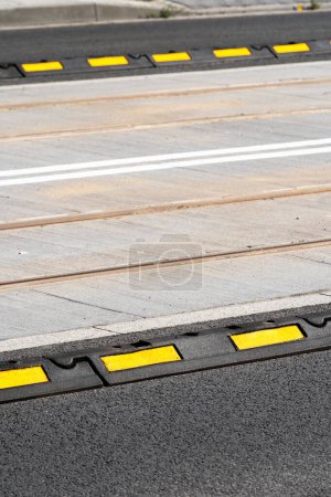 Designation of lane for transport on road with boundary delineator. Warning elements on carriageway. Closeup of separator lines on roadway for cars. Safety concept. Traffic rules