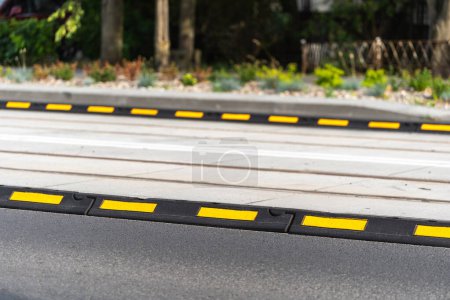 Photo for Asphalt road and boundary delineator for control traffic of city transport. Closeup on separator lines for cars on carriageway. Roadway marking, warning elements - Royalty Free Image