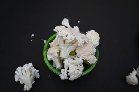 Cauliflower on black background. It is one of several vegetables in the species in the genus Brassica, which is in the Brassicaceae family. Its other names Brassica oleracea, Brussels sprouts and cole.