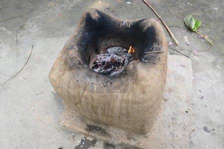 Clay stove. This is a type of cooking stove. It is used in rural area for cooking and heating.Traditional stoves used by residents in rural India. Wood fire is burning in the earthen or mud stove.