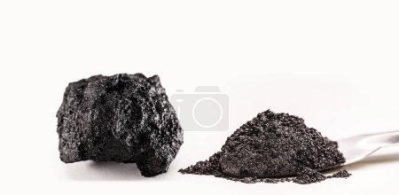 Foto de Graphite, graphite powder and ore, industrial use, isolated white background - Imagen libre de derechos