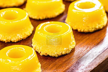 Photo for Quindim, or "quin dim", homemade sweet typical of Brazil, made with egg yolk, sugar and grated coconut. - Royalty Free Image