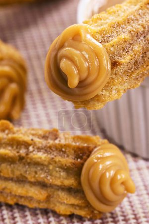 Photo for Churros, fried sweet stuffed with dulce de leche, traditional from Brazil - Royalty Free Image
