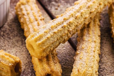 Photo for Churros, a traditional fried sweet from Latin America, Brazil, Colombia, the United States and Portugal, served with or without filling, sprinkled with sugar - Royalty Free Image