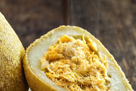 typical Brazilian salty, called "coxinha" of chicken, made with shredded chicken, flour and pasta. Chicken leg cut in half.