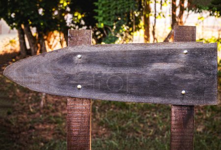 wooden sign in rural environment, signpost, outdoors, sunny day, with space for text, mockup