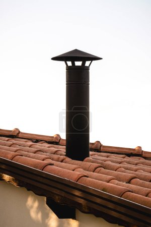 Black Chimney With Chinese Hat For Barbecue, typical Brazilian barbecue chimney, on a ceramic roof, Industrial style barbecue chimney