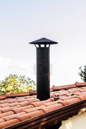 Black Chimney With Chinese Hat For Barbecue, typical Brazilian barbecue chimney, on a ceramic roof, Industrial style barbecue chimney