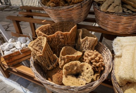 Photo for Wicker baskets filled with natural greek sponges at the gift shop, Symi island, Greece. - Royalty Free Image