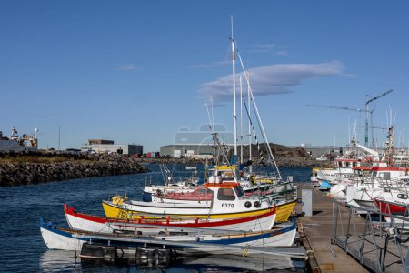 Photo for Reykjavik, Iceland - September 25, 2023: Colorful fishing boats and sailboats moored in the Karsnes harbour, Kopavogur. - Royalty Free Image