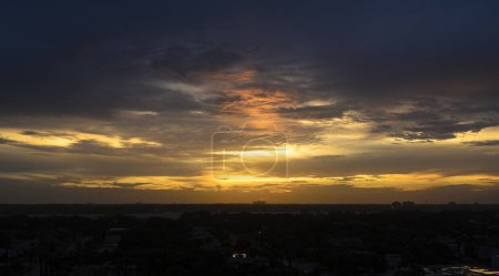 Photo for Sunbeam illuminating coral cloud patch at dusk - Royalty Free Image