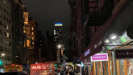 Photo for Ukrainian flag lighting on top of a Midtown Manhattan, New York City building in solidarity with Ukraine taken on 1-31-2023 from the Upper East Side - Royalty Free Image