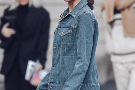 Photo for Milan, Italy - February 25, 2022: Crop anonymous female in denim outfit with blue Tod's handbag with chain walking on street. - Royalty Free Image