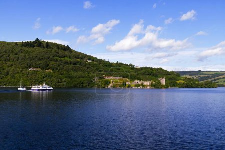 Photo for Step aboard an unforgettable journey as this photograph captures a passenger ship full of tourists sailing toward the storied ruins of Urquhart Castle on Loch Ness. Known for its rich history and - Royalty Free Image