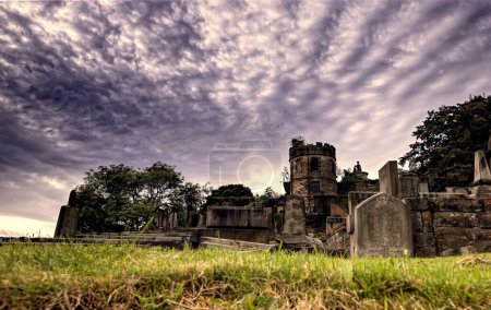 Photo for Step into a realm of peaceful solitude within the bustling heart of Edinburgh, Scotland. This hauntingly beautiful photograph reveals the time-worn gravestones and intricate sculptures that populate - Royalty Free Image