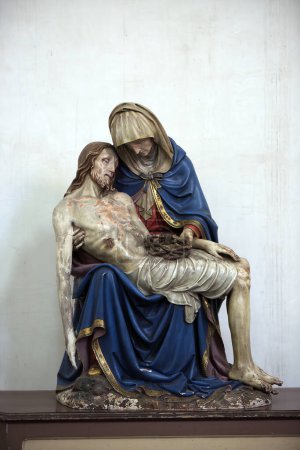 Photo for This evocative image captures a Pieta sculpture with the Virgin Mary holding the lifeless body of Jesus Christ. The poignant expression of sorrow and maternal love is masterfully depicted in the - Royalty Free Image