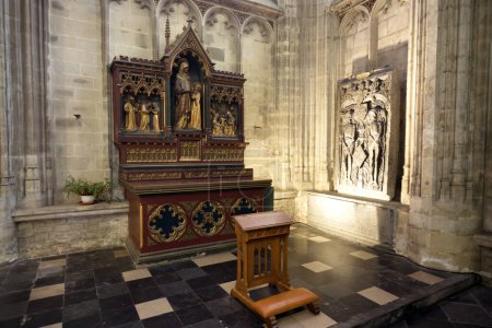 Photo for This photograph captures the richly decorated altar and lectern within the hallowed space of a medieval cathedral. The altars Gothic architecture, combined with the intricate patterns and vibrant - Royalty Free Image