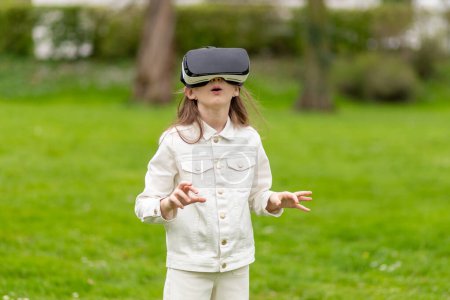 Girl in virtual reality headset looking up in a park.